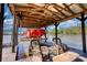 Covered boat dock with boat lift and wicker furniture seating area perfect for relaxing and enjoying waterfront views at 480 Friar Tuck Cir, Covington, GA 30014