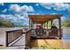 Covered boat dock featuring a grill and seating area, perfect for entertaining with a lake view at 480 Friar Tuck Cir, Covington, GA 30014