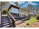 Back of charming multi-level home featuring a staircase, a deck, a mix of siding styles and a well manicured lawn at 480 Friar Tuck Cir, Covington, GA 30014