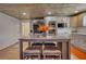 Open-concept kitchen with stainless steel appliances, a central island with seating, and white cabinetry at 480 Friar Tuck Cir, Covington, GA 30014