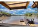 Lake view from house featuring covered dock with boat lift, grill and seating area perfect for entertaining Gathering and friends at 480 Friar Tuck Cir, Covington, GA 30014