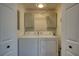 Laundry room with washer, dryer, and storage cabinets at 480 Friar Tuck Cir, Covington, GA 30014