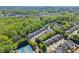 Aerial view of a residential area featuring many townhomes and lush greenery at 12150 Dancliff Trce, Alpharetta, GA 30009