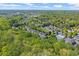 An aerial view of community surrounded by trees, a pool and tennis courts at 12150 Dancliff Trce, Alpharetta, GA 30009