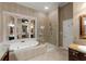 Luxurious bathroom with a soaking tub, separate shower, and granite countertops at 12150 Dancliff Trce, Alpharetta, GA 30009