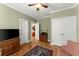 Versatile bedroom space featuring a TV, ample storage, neutral walls and access to an adjacent room via a wide doorway at 12150 Dancliff Trce, Alpharetta, GA 30009