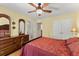 Comfortable bedroom featuring a large bed, dresser, and ample closet space, with natural light from the windows at 12150 Dancliff Trce, Alpharetta, GA 30009