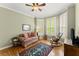 Cozy bedroom featuring a comfortable couch, a rocking chair and a large rug, creating a relaxing retreat at 12150 Dancliff Trce, Alpharetta, GA 30009