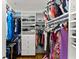 Walk-in closet with custom shelving and plenty of storage space for clothes and accessories at 12150 Dancliff Trce, Alpharetta, GA 30009