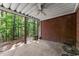 Brick and concrete patio with ceiling fan, shade, and views of the green forested landscape at 12150 Dancliff Trce, Alpharetta, GA 30009