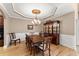 Formal dining room featuring hardwood floors, elegant chandelier, wainscoting and ample seating for dinner parties at 12150 Dancliff Trce, Alpharetta, GA 30009