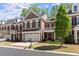 Elegant brick home featuring a two-car garage, black shutters, and a landscaped yard at 12150 Dancliff Trce, Alpharetta, GA 30009