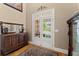 Bright entryway featuring hardwood floors, decorative rug, and glass french doors leading to an outdoor area at 12150 Dancliff Trce, Alpharetta, GA 30009