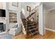Grand foyer showcasing a staircase with custom ironwork, hardwood floors, and sophisticated architectural details at 12150 Dancliff Trce, Alpharetta, GA 30009