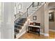 Elegant foyer with hardwood floors, staircase with iron railings, and decorative console table, offering a welcoming entrance at 12150 Dancliff Trce, Alpharetta, GA 30009
