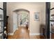 Elegant foyer with hardwood floors, an arched doorway, and a staircase leading to the upper level at 12150 Dancliff Trce, Alpharetta, GA 30009