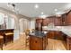 Well-equipped kitchen with a center island, granite countertops, and stainless steel appliances at 12150 Dancliff Trce, Alpharetta, GA 30009