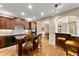 Stylish kitchen featuring wood cabinets, granite countertops, a breakfast bar, and seamless access to the dining area at 12150 Dancliff Trce, Alpharetta, GA 30009
