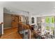 Open floor plan with hardwood floors and staircase overlooking the living room with large windows at 12150 Dancliff Trce, Alpharetta, GA 30009