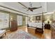 Comfortable bedroom with a four-poster bed, hardwood floors, and plantation shutters at 12150 Dancliff Trce, Alpharetta, GA 30009