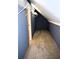 A spacious attic storage area with slanted ceilings, carpeted floors, and blue walls at 1521 Larkwood Dr, Canton, GA 30114