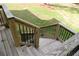 Backyard view from the deck with wood railings and stairs leading down to the lawn at 1521 Larkwood Dr, Canton, GA 30114