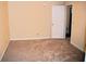 Spacious bedroom with neutral carpeting, light walls, and a door leading to an attached closet at 1521 Larkwood Dr, Canton, GA 30114