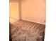 A bright bedroom with a doorway, featuring neutral walls and neutral carpet at 1521 Larkwood Dr, Canton, GA 30114