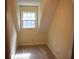 A compact closet featuring natural light from a window and neutral carpeting at 1521 Larkwood Dr, Canton, GA 30114