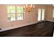 Dining room featuring hardwood floors, a chandelier, and a large window with natural light at 1521 Larkwood Dr, Canton, GA 30114