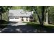 Charming home with a two-car garage, stone facade, and a cozy deck surrounded by lush greenery at 1521 Larkwood Dr, Canton, GA 30114