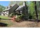 Exterior view of the home with a chimney, garage, and lush landscaping at 1521 Larkwood Dr, Canton, GA 30114