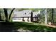 Home exterior with a lush green lawn and a long driveway at 1521 Larkwood Dr, Canton, GA 30114