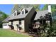 Charming home featuring a stone facade, dormer windows, and a inviting front deck at 1521 Larkwood Dr, Canton, GA 30114