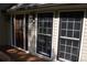 Inviting front entrance with leaded glass door and sidelight, flanked by light fixtures and windows at 1521 Larkwood Dr, Canton, GA 30114