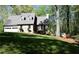 Beautiful exterior showcasing the home's design, a manicured lawn, and mature trees at 1521 Larkwood Dr, Canton, GA 30114