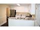 Updated kitchen with stainless steel appliances, marble countertops, and white cabinets at 1521 Larkwood Dr, Canton, GA 30114