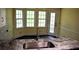Kitchen featuring marble counters, stainless steel sink, and natural light from windows and door at 1521 Larkwood Dr, Canton, GA 30114