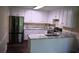 Bright kitchen with stainless steel refrigerator, elegant countertops and ample white cabinetry at 1521 Larkwood Dr, Canton, GA 30114