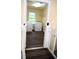 Clean and functional laundry room, featuring a washer, dryer, and durable dark wood laminate flooring at 1521 Larkwood Dr, Canton, GA 30114