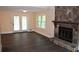 Spacious living room with a stone fireplace, hardwood floors, and access to the outside at 1521 Larkwood Dr, Canton, GA 30114