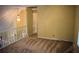 Loft area featuring neutral walls, carpet, and a hanging pendant light at 1521 Larkwood Dr, Canton, GA 30114