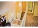 Loft featuring neutral paint and carpet with views of the front door and stairs at 1521 Larkwood Dr, Canton, GA 30114