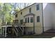 The back of the home, showing the deck with stairs down to the backyard at 1521 Larkwood Dr, Canton, GA 30114