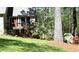 Landscaped yard with mature plants surrounding the entrance of the home with a stone facade at 1521 Larkwood Dr, Canton, GA 30114