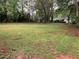 Expansive, flat backyard space with mature trees and ample room for outdoor activities at 1871 Kinridge Rd, Marietta, GA 30062