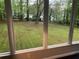 View of the expansive and well-maintained backyard, seen from the screened-in porch at 1871 Kinridge Rd, Marietta, GA 30062