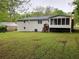 Large backyard with mature trees; back of house showing screened in porch at 1871 Kinridge Rd, Marietta, GA 30062