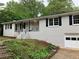 White brick house with dark shutters and attached garage at 1871 Kinridge Rd, Marietta, GA 30062