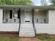 Detailed view of the home's entryway with a white door and decorative railing at 1871 Kinridge Rd, Marietta, GA 30062